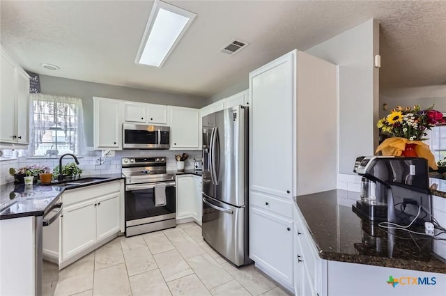 4201 Breckenridge Dr, Killeen, TX 76542 - kitchen with stainless steel appliances, tasteful backsplash, and white cabinets