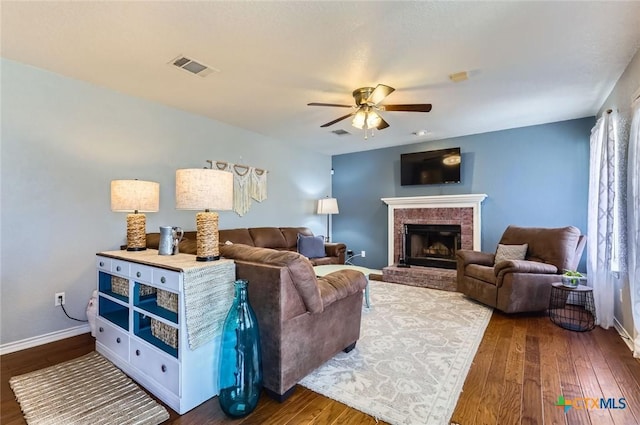 4201 Breckenridge Dr, Killeen, TX 76542 - living area with dark wood-type flooring, ceiling fan, a brick fireplace, and plenty of natural light