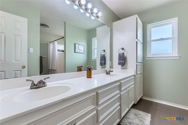 4201 Breckenridge Dr, Killeen, TX 76542 - full bathroom with double vanity, wood finished floors, healthy amount of natural light, and a shower with shower curtain