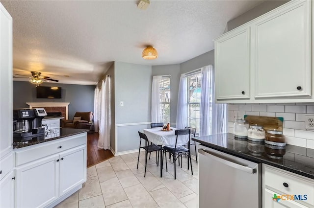 4201 Breckenridge Dr, Killeen, TX 76542 - kitchen featuring dishwasher, tasteful backsplash, ceiling fan, a fireplace, and white cabinetry