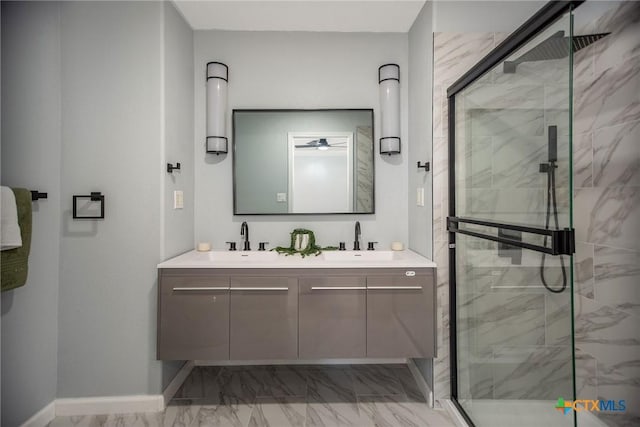 full bathroom featuring marble finish floor, a marble finish shower, and a sink