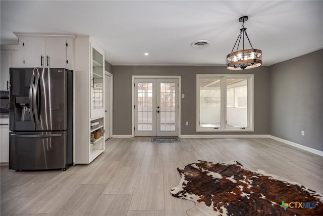 kitchen featuring french doors, stainless steel fridge with ice dispenser, visible vents, white cabinetry, and baseboards