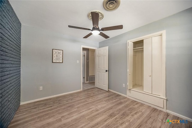 unfurnished bedroom with a ceiling fan, a closet, baseboards, and wood finished floors