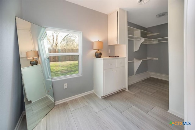 walk in closet featuring wood tiled floor