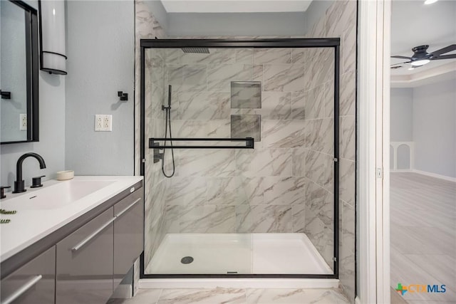 full bathroom with ceiling fan, marble finish floor, a stall shower, and vanity