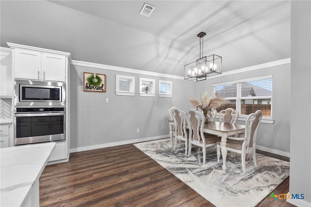 dining area featuring lofted ceiling, visible vents, dark wood-type flooring, ornamental molding, and baseboards