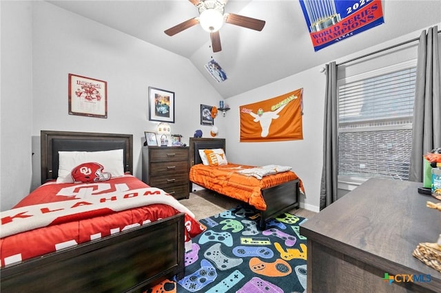 carpeted bedroom with lofted ceiling, a ceiling fan, and baseboards