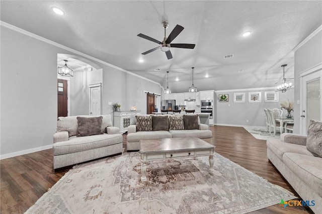 living room featuring ornamental molding, dark wood finished floors, baseboards, and ceiling fan with notable chandelier