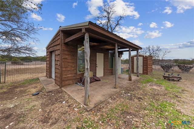 view of shed with fence