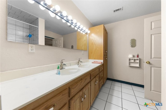 bathroom with tile patterned flooring, a sink, visible vents, and double vanity