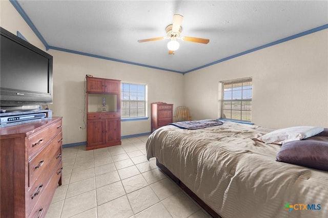 bedroom featuring a ceiling fan, baseboards, ornamental molding, and light tile patterned floors