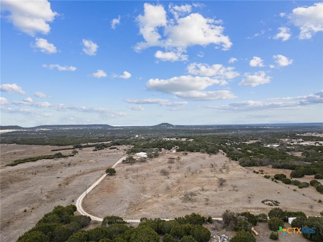 drone / aerial view with a rural view, view of desert, and a mountain view