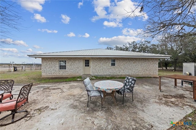 view of patio featuring outdoor dining area and fence