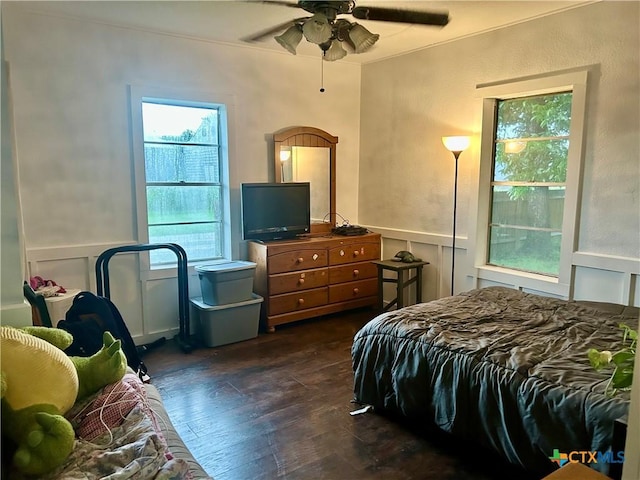 101 Alva St, Thrall, TX 76578 - bedroom with dark wood-style floors, a ceiling fan, and a wainscoted wall
