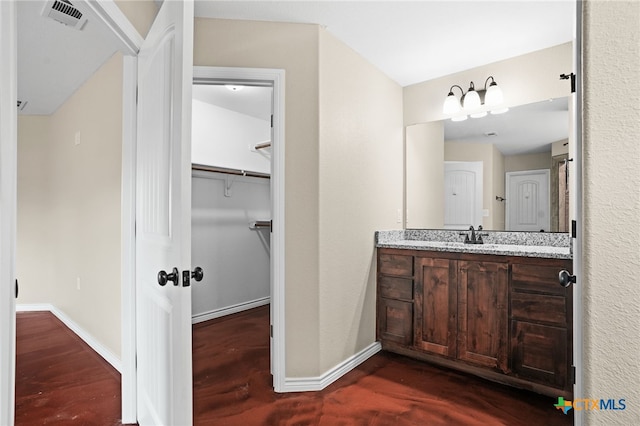 bathroom featuring hardwood / wood-style flooring and vanity