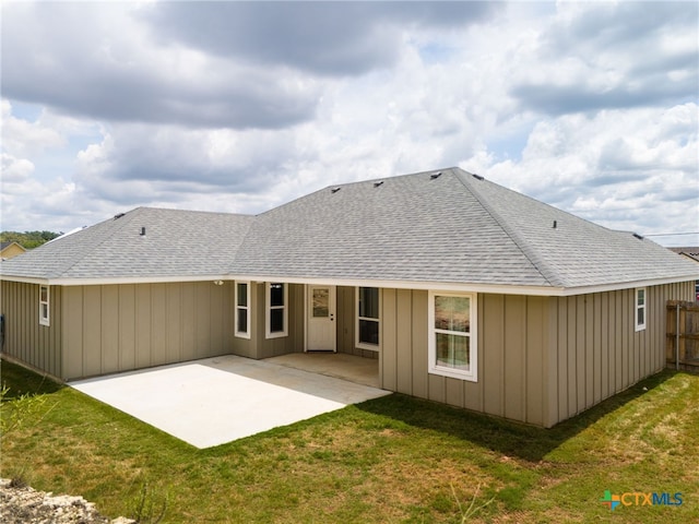 rear view of house featuring a yard and a patio