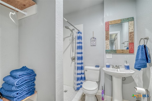 bathroom with walk in shower, tile patterned flooring, sink, and toilet