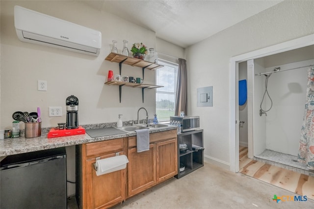 kitchen featuring stainless steel appliances, a wall unit AC, sink, and light hardwood / wood-style floors