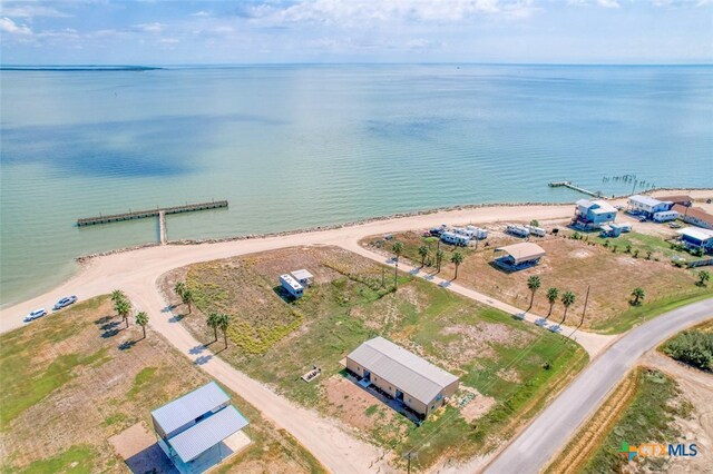 drone / aerial view featuring a beach view and a water view