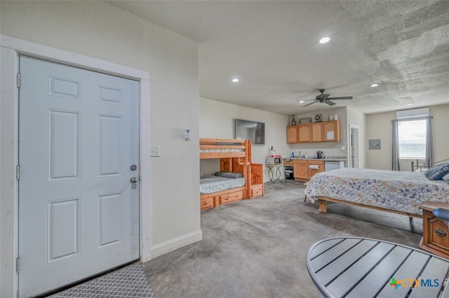 bedroom with a textured ceiling, light colored carpet, and ceiling fan