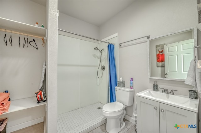 bathroom featuring toilet, vanity, and a shower with shower curtain