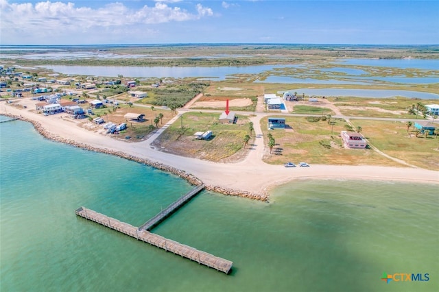 birds eye view of property with a beach view and a water view