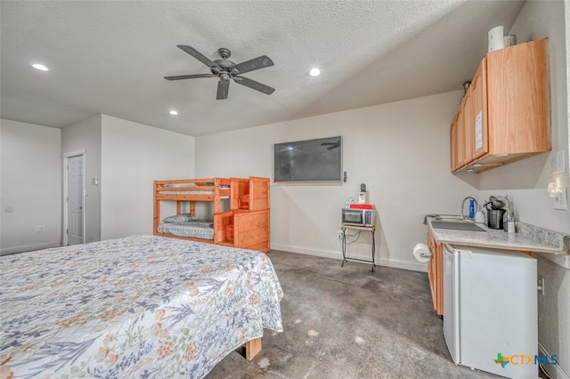 carpeted bedroom with ceiling fan, a textured ceiling, and sink