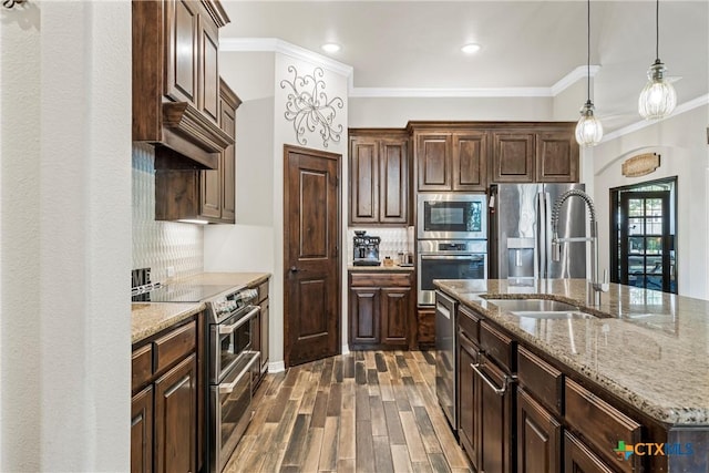 6 Salta Ct, Belton, TX 76513 - kitchen featuring appliances with stainless steel finishes, a sink, crown molding, tasteful backsplash, and light stone countertops