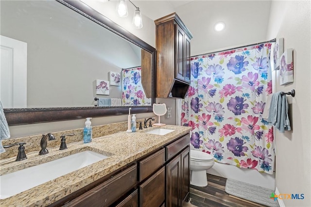 6 Salta Ct, Belton, TX 76513 - bathroom with wood finished floors, toilet, double vanity, and shower / bathtub combination with curtain