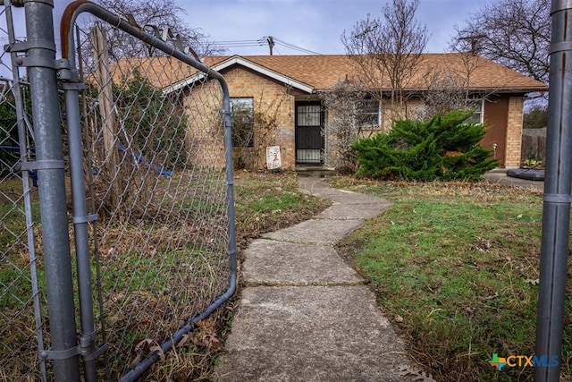 single story home with roof with shingles