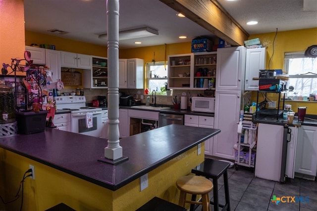 kitchen with open shelves, dark countertops, white cabinets, a sink, and white appliances