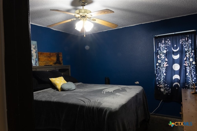 bedroom featuring a textured ceiling and a ceiling fan