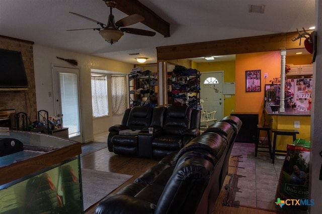 living area with lofted ceiling with beams, ceiling fan, visible vents, and wood finished floors