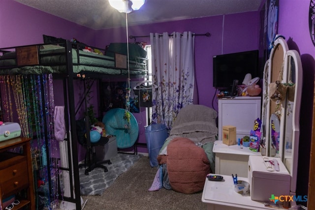 bedroom featuring carpet floors and a textured ceiling