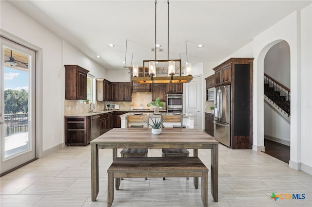 dining area featuring wine cooler, a notable chandelier, and sink