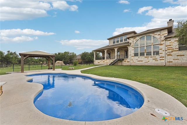 view of swimming pool with a gazebo and a yard