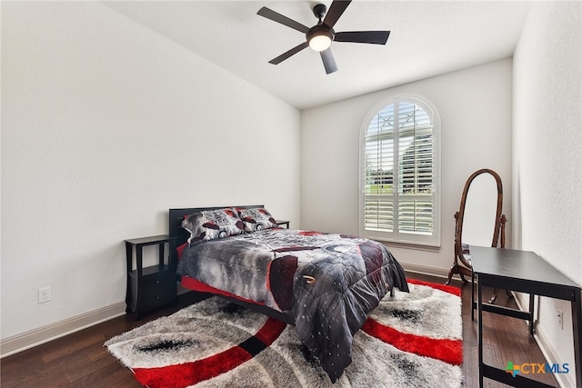 bedroom with ceiling fan and dark hardwood / wood-style flooring