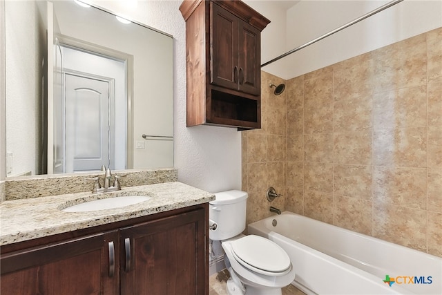 full bathroom featuring toilet, vanity, and tiled shower / bath