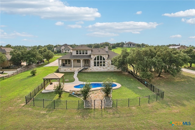 rear view of house featuring a gazebo, a yard, a fenced in pool, and a patio