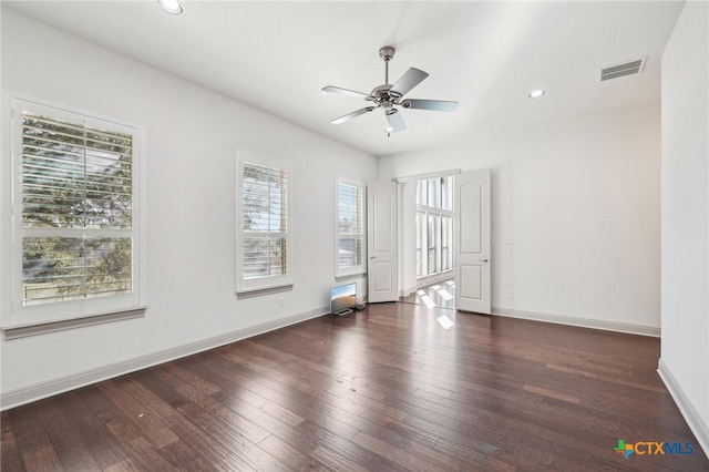 unfurnished room with dark hardwood / wood-style flooring, plenty of natural light, and ceiling fan