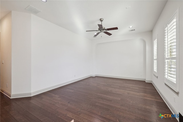 unfurnished room featuring ceiling fan and dark hardwood / wood-style flooring