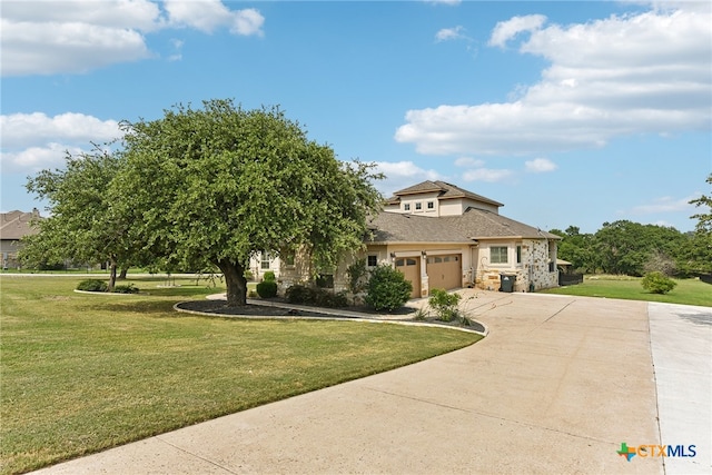 view of front facade with a front yard and a garage