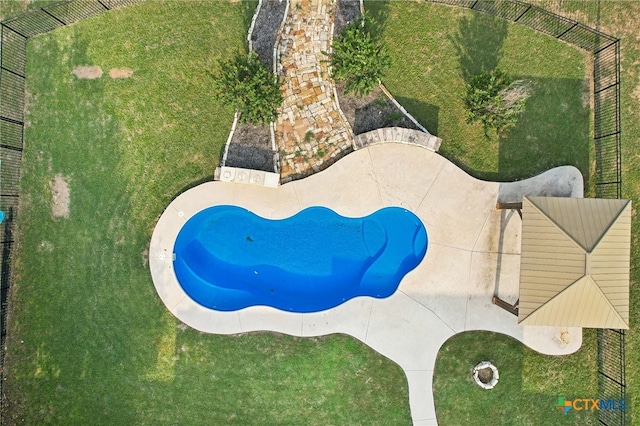 view of swimming pool featuring a yard and a patio