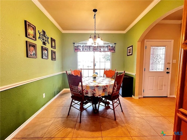 tiled dining area with crown molding and a chandelier