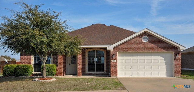 view of front of property with a front lawn and a garage