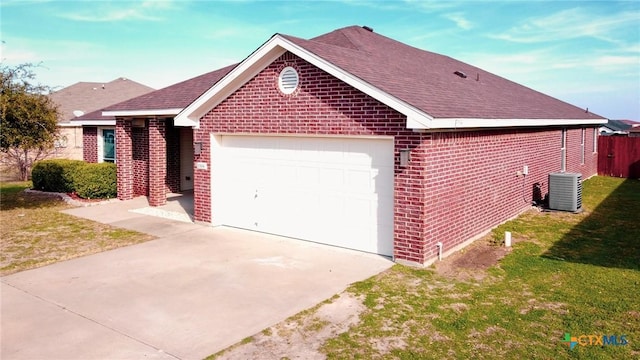 ranch-style home with a front lawn, cooling unit, and a garage