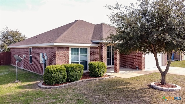 view of front of home with a front yard and a garage