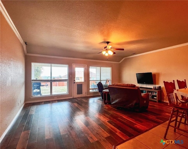 living room featuring ceiling fan, a textured ceiling, dark hardwood / wood-style flooring, and crown molding