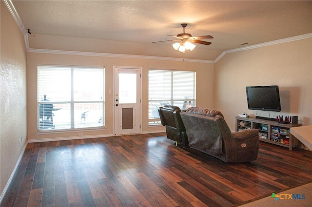 living room with ceiling fan, a healthy amount of sunlight, dark hardwood / wood-style flooring, and crown molding