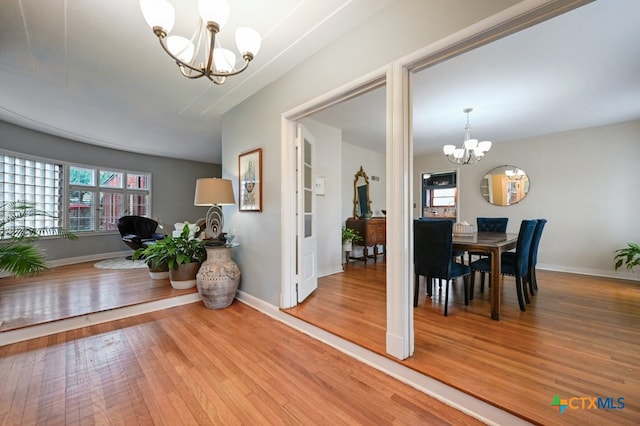 dining space featuring an inviting chandelier and wood-type flooring